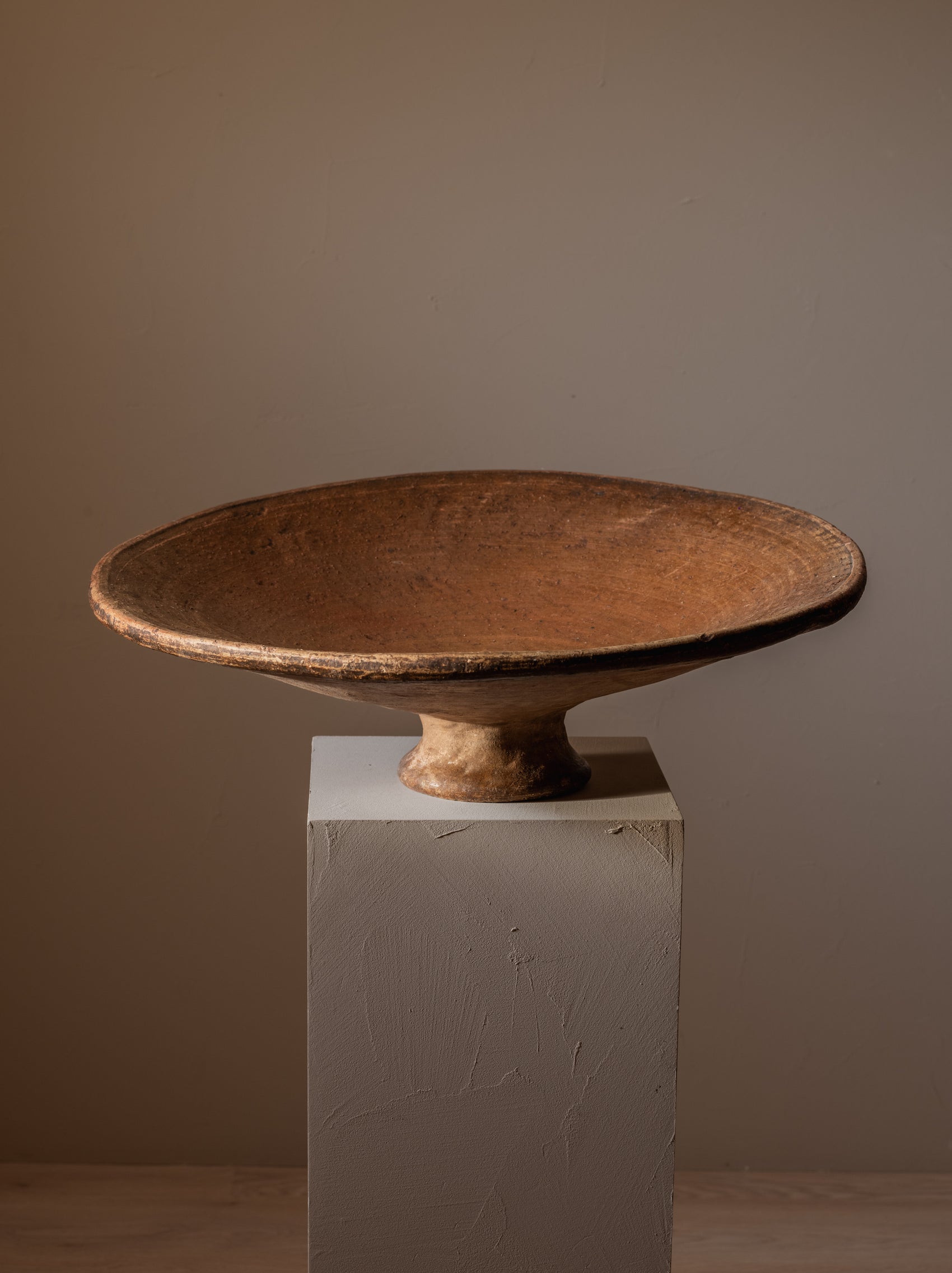 Large terracotta serving dish with foot